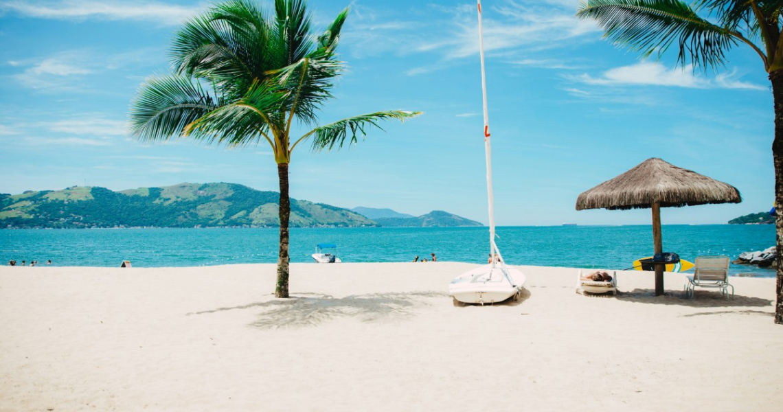 the beach and occean with sailboat